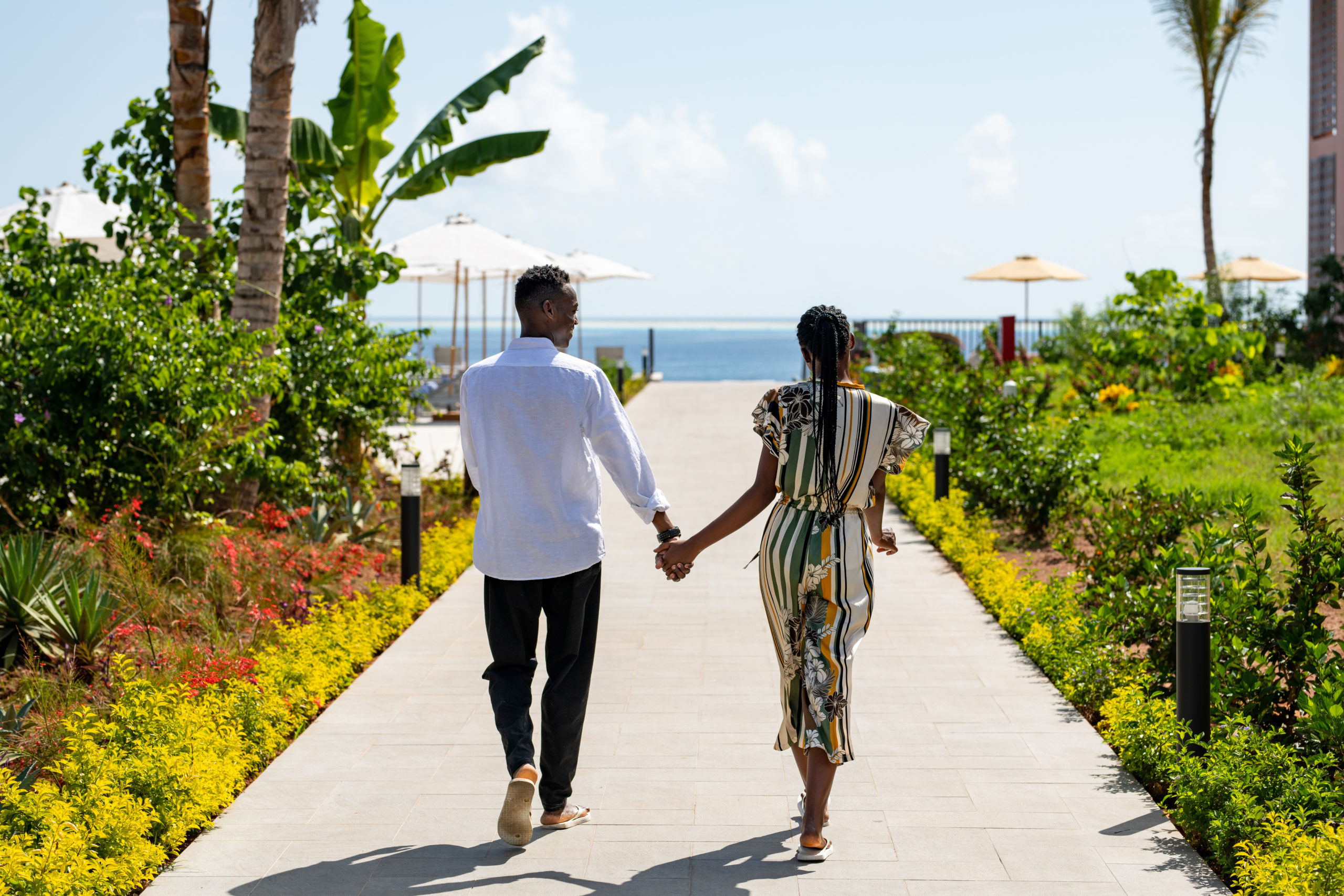 Couple walking together at a tropical coastal resort
